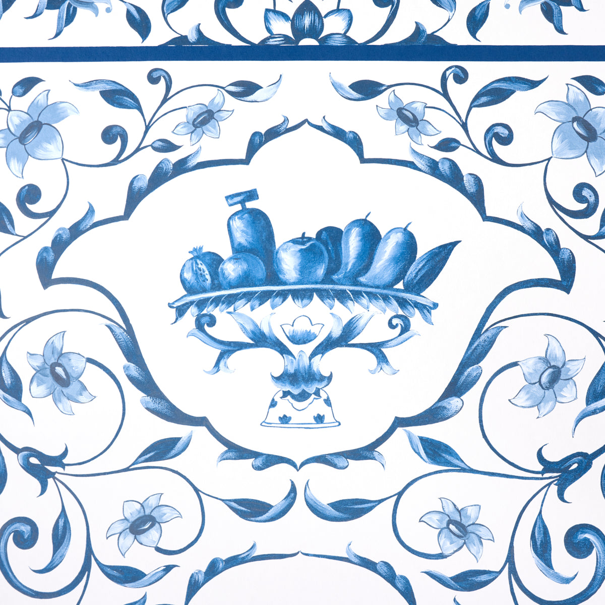 Blue and white Delftware ceramic tile with central fruit basket on a pedestal, surrounded by scrolling floral patterns.