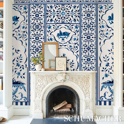 Blue decorative wall panel with an intricate white pattern on a blue background.