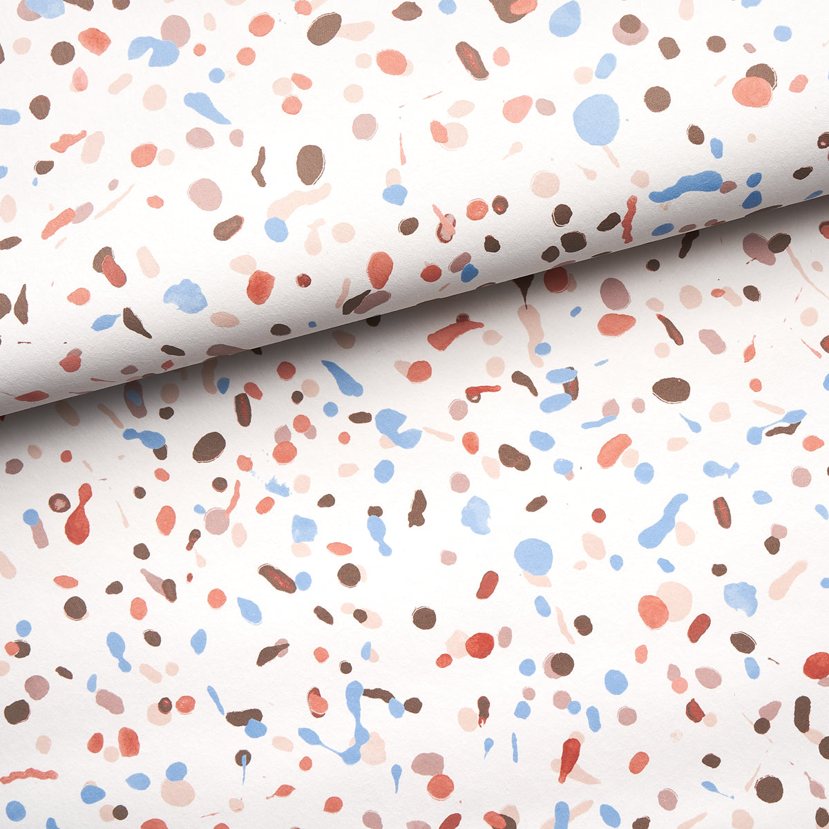 Rolled backdrop fabric featuring terrazzo-inspired speckled print in blue, peach, pink, and brown.