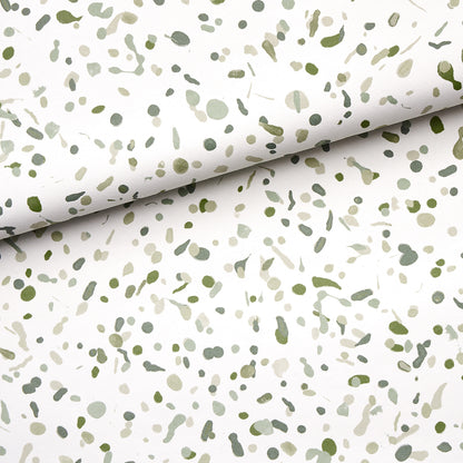 Moss-green backdrop fabric with olive-green speckled confetti pattern; rolled backdrop.
