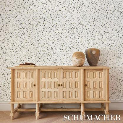 Moss green wallpaper with a subtle speckled pattern.