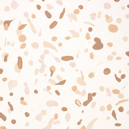Terrazzo-style pattern with peach, beige and tan chips scattered on a cream background.