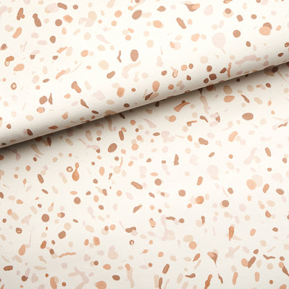 Cream backdrop with peach and light brown terrazzo speckle pattern, rolled edge.
