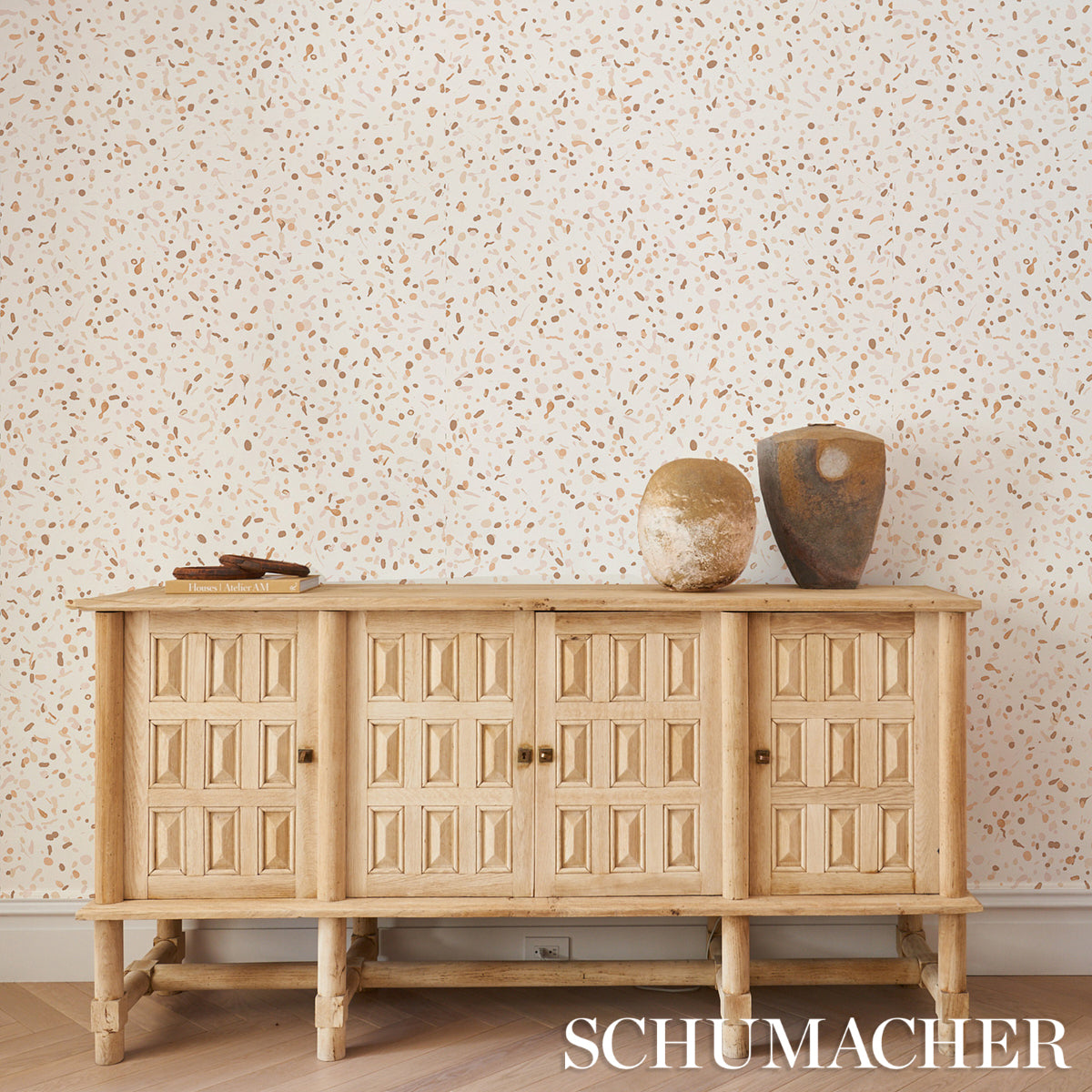Earth-toned wallpaper backdrop with a subtle pattern.