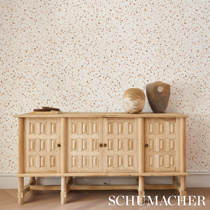 Earth-toned wallpaper backdrop with a subtle pattern.