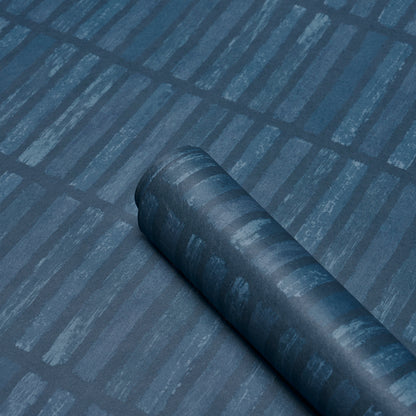 Dark blue rolled fabric swatch on a blue striped surface; matte finish, versatile textile display.