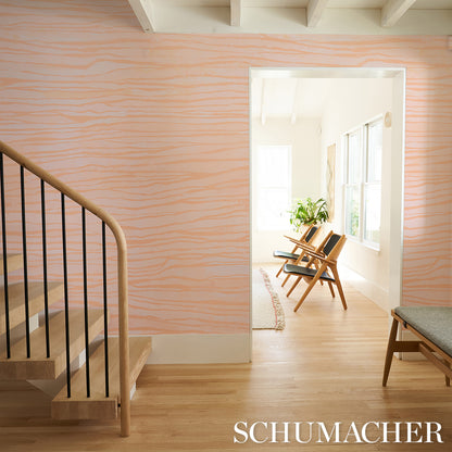 Peach wall panels with soft orange wavy stripes; wooden staircase and a bright sunlit living room with mid-century chairs.