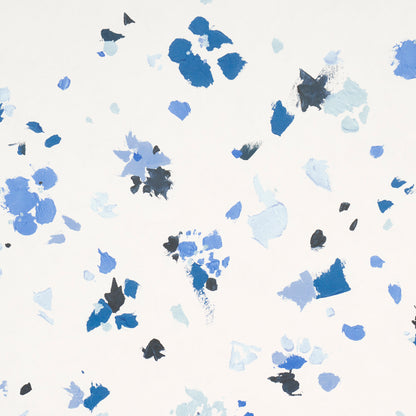 Abstract paint-splatter pattern in blues and grays.