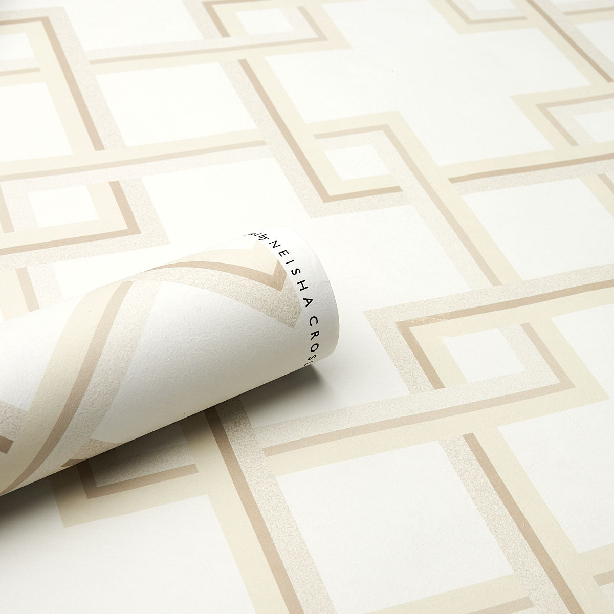 Beige geometric wallpaper with interlocking square/Greek-key motif on light background; rolled corner reveals backing.