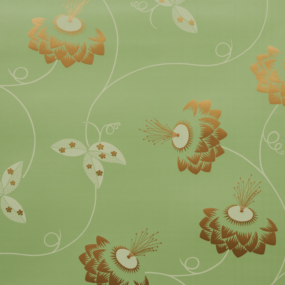 Green fabric featuring large orange-brown stylized flowers with white swirls, decorative floral textile pattern.