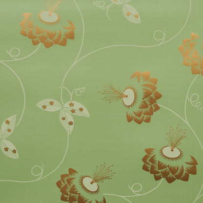 Green fabric featuring large orange-brown stylized flowers with white swirls, decorative floral textile pattern.