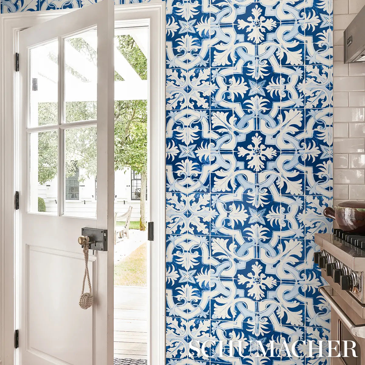Blue Azulejos tile wallpaper by Mary McDonald for Schumacher, luxury designer wallcovering with Portuguese tile inspired geometric pattern in cobalt and azure, ideal for coastal, Mediterranean, and high-end interior design accent walls.