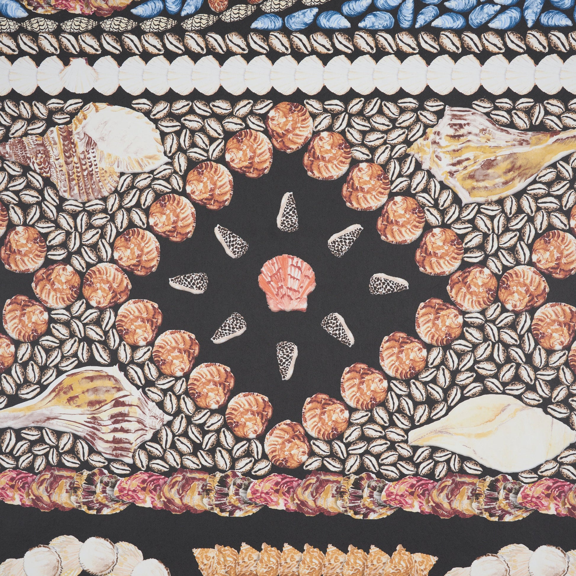 Panel design featuring a bold black central star motif, orange bead circles, shell-and-leaf motifs, and a blue and white border on an onyx multi background.