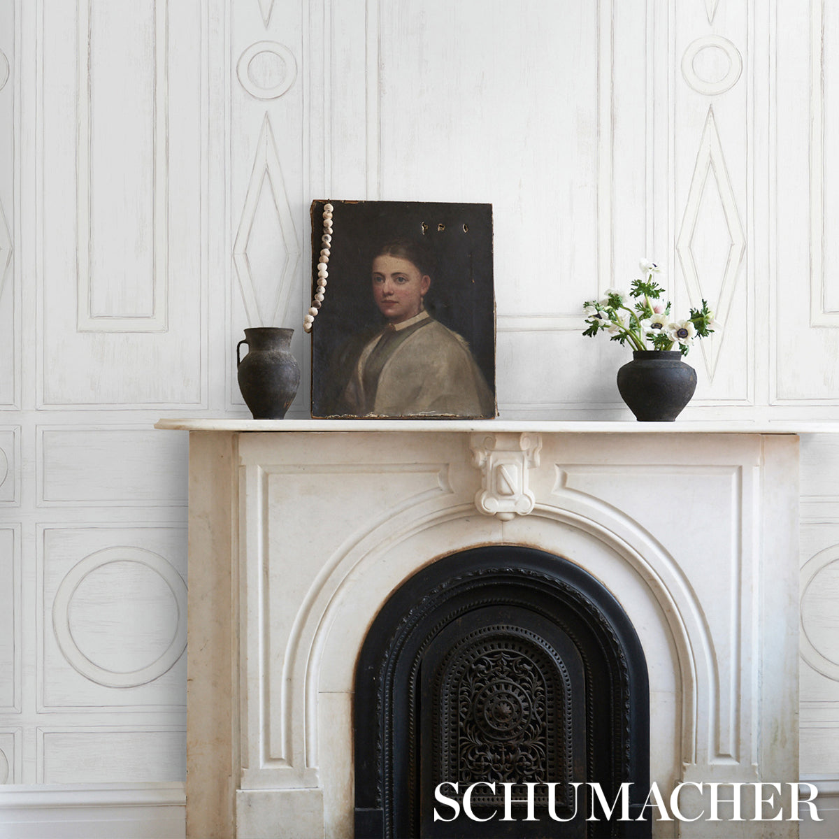 Panel design featuring a vintage portrait on a marble mantel with beaded necklace, black ceramic jug, vase of white flowers, and a cast-iron grate.