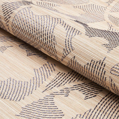 Beige woven fabric with dark blue abstract leaf motif, rolled on a bolt; upholstery or curtain textile.