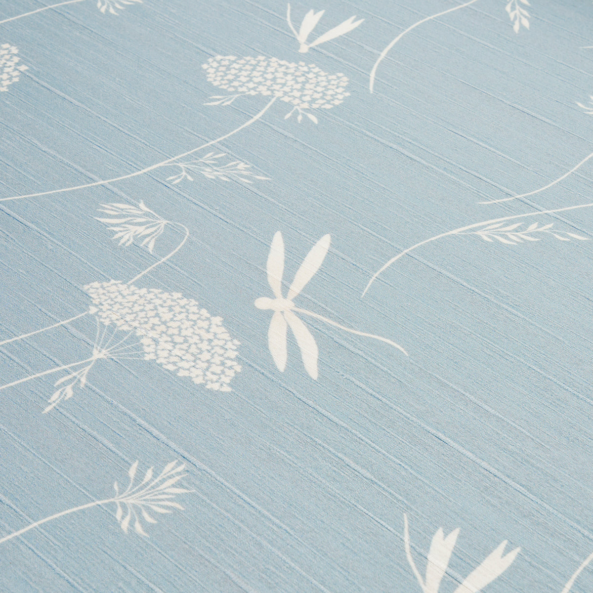 Light blue wallcovering with white dragonflies and botanical seedhead motifs in a flowing pattern.