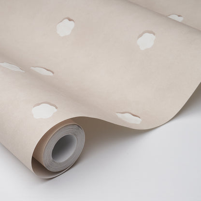 Beige wallpaper roll with white cloud-like spots, rolled up to show the cardboard core.