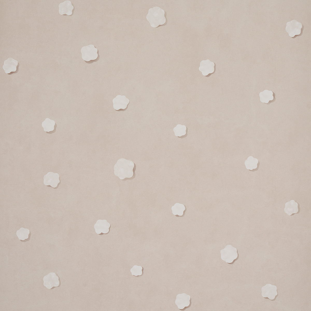 Beige-pink wallpaper with small white five-petal flowers scattered across.