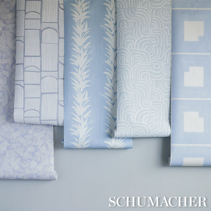 Wallpaper swatches with geometric blocks, arched motifs, fern-like botanical pattern and lattice in cool lilac.