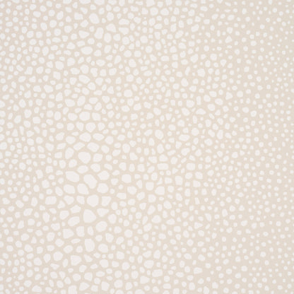 Beige textured wallpaper with scattered white pebble-like spots creating an organic, speckled pattern.