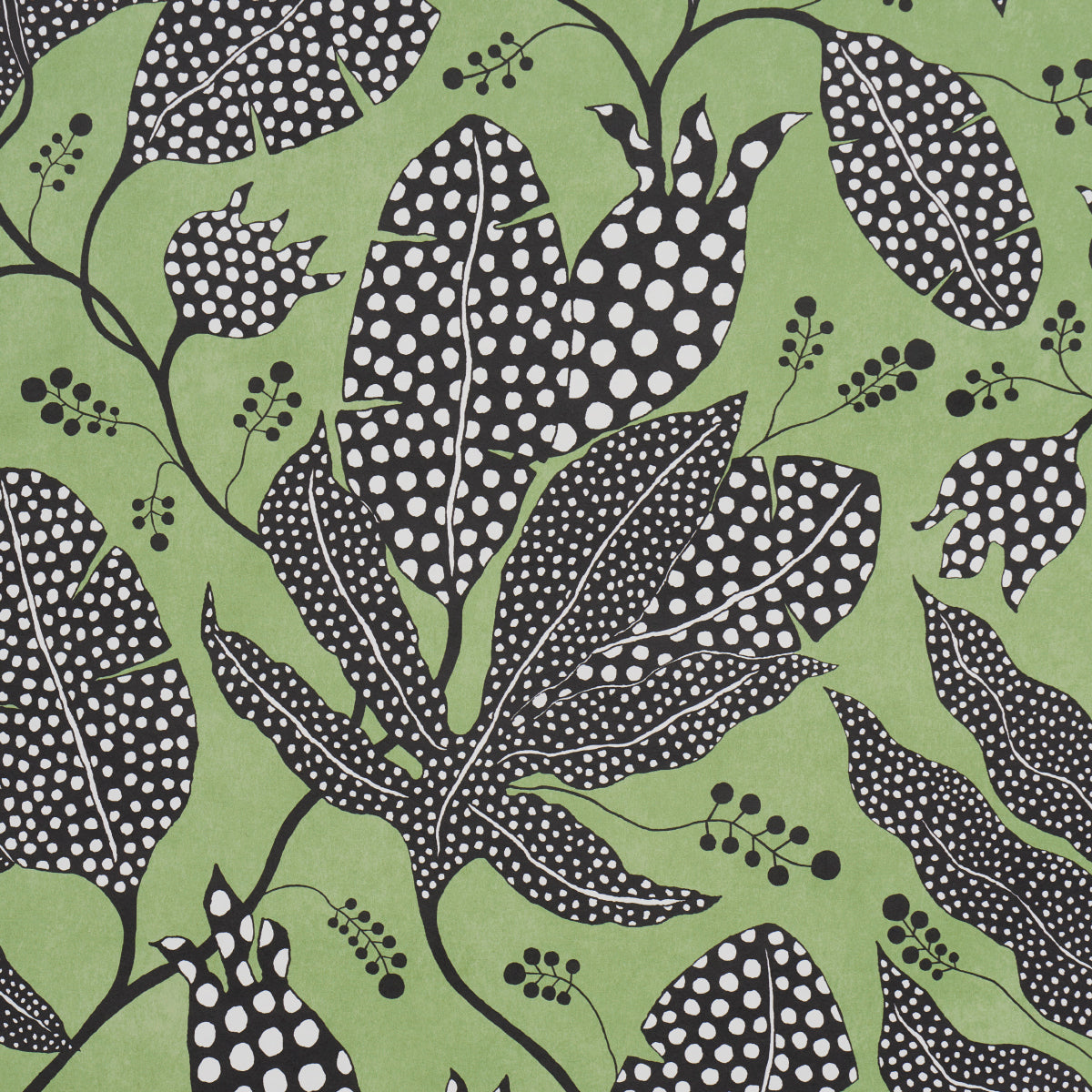 Green fabric featuring black leaves with white polka dots and delicate berry clusters in a bold botanical print.