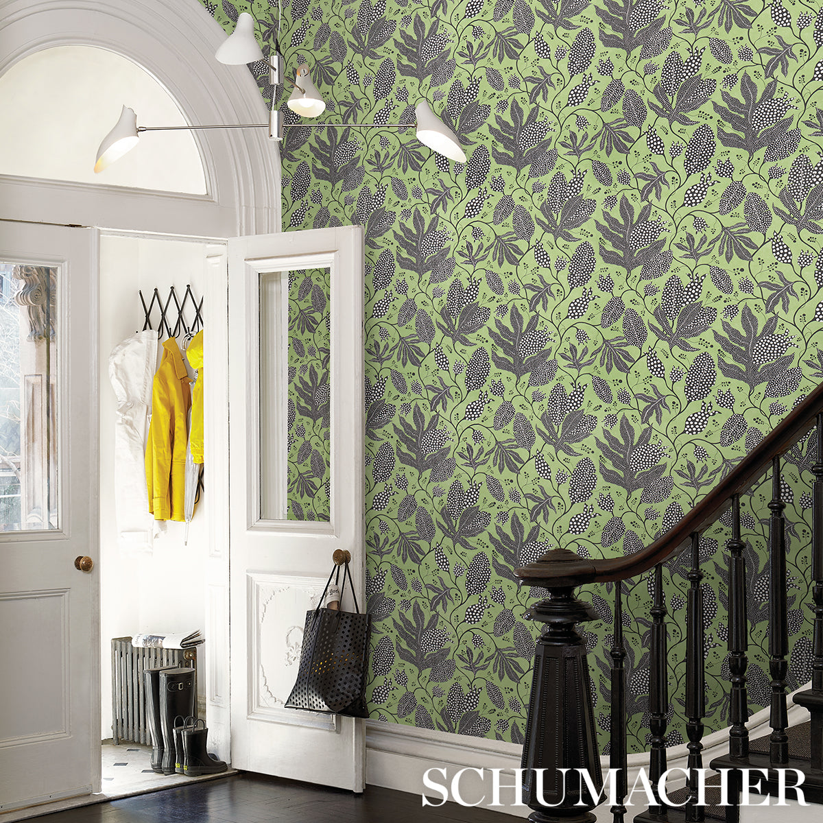 Green botanical wallpaper with dark leaves.