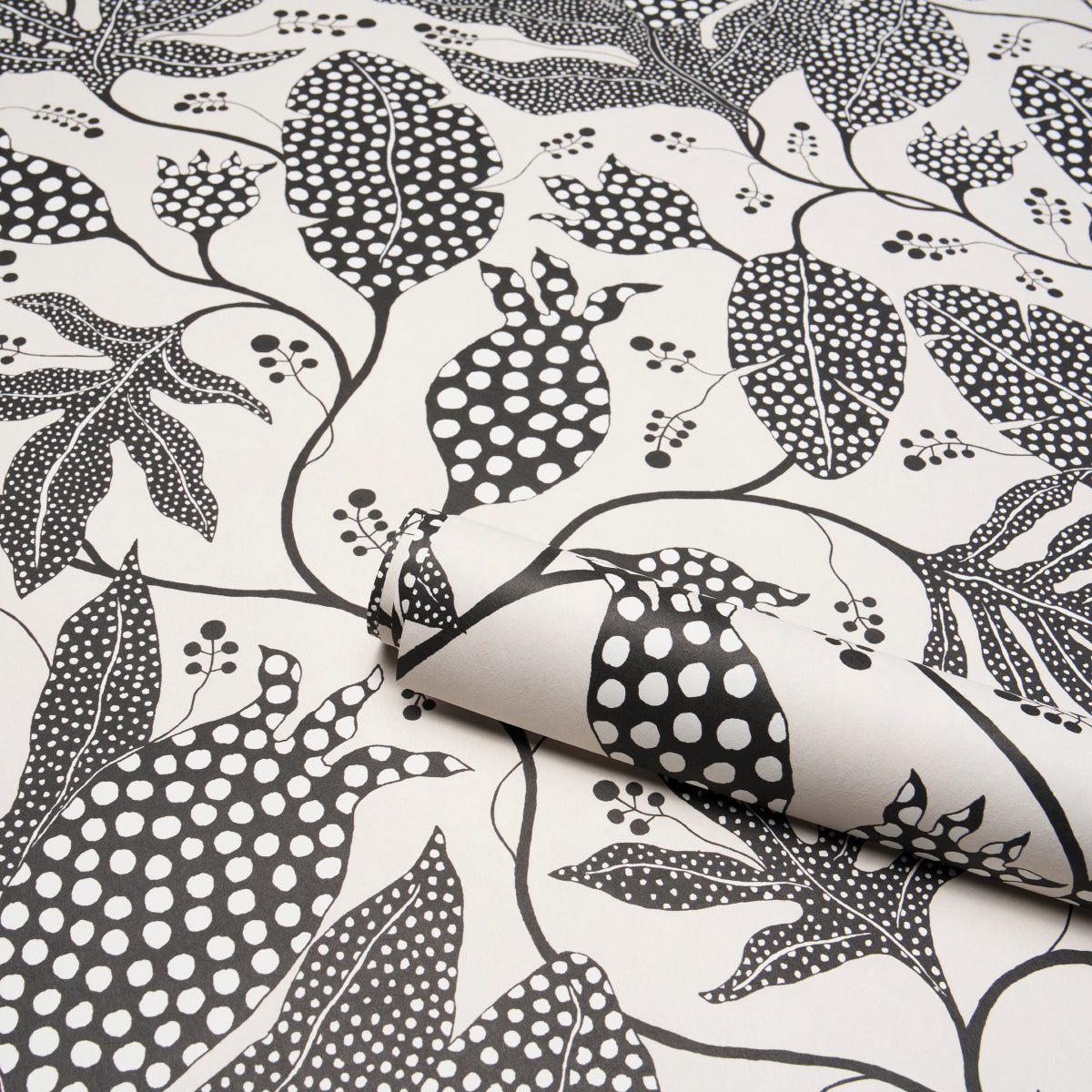 Cream fabric with black polka-dot jungle botanical print and twisting vines; folded corner.
