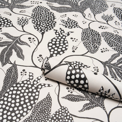Cream fabric with black polka-dot jungle botanical print and twisting vines; folded corner.