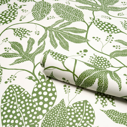 Green polka-dot jungle print on ivory background; rolled decor fabric.