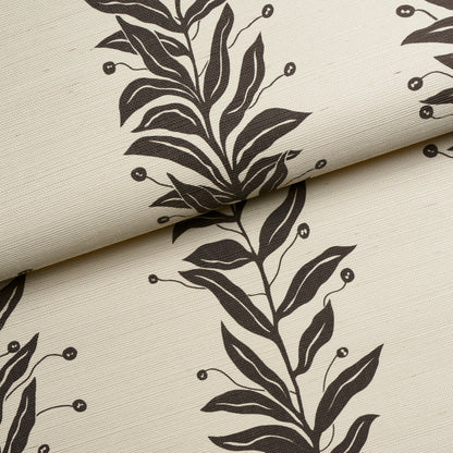 Beige sisal fabric swatch with a tendril stripe pattern in black and cream, folded edge.
