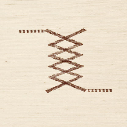 Brown embroidery on light beige fabric featuring stacked diamond zigzags with short horizontal stitches at ends.