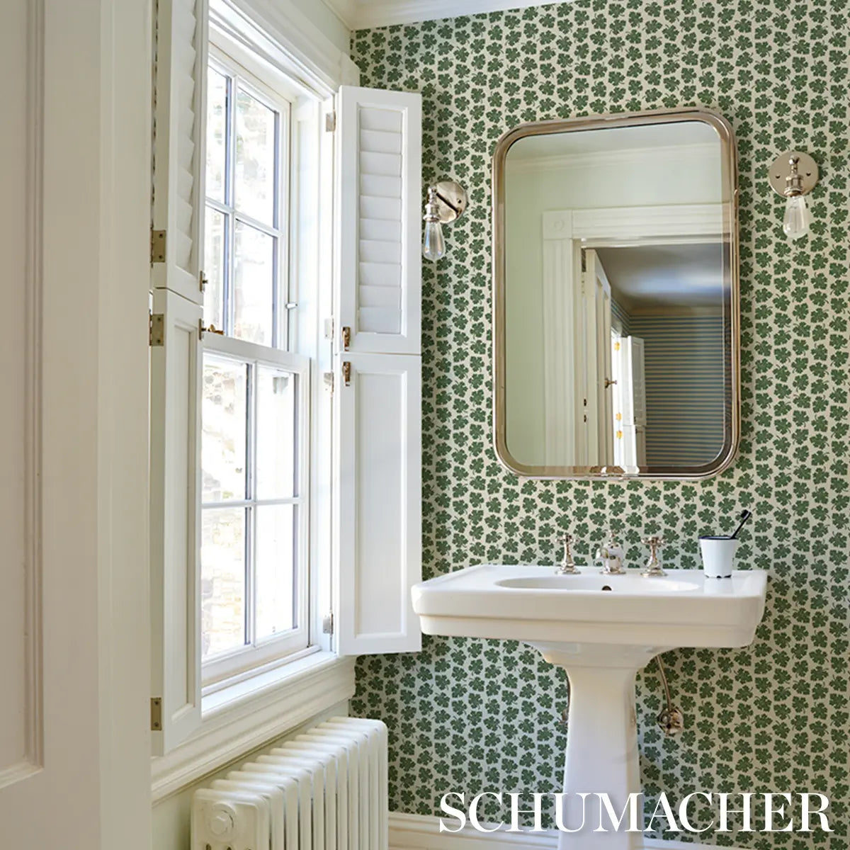 Rita Konig Olive Wallpaper in Green featuring a small-scale multidirectional botanical leaf pattern inspired by 18th-century wallpaper designs. This luxury Schumacher wallpaper showcases delicate gravure-printed olive leaves on a smooth non-woven paper ground, creating a refined and timeless look. Ideal for living rooms, bedrooms, dining rooms, hallways, powder rooms, cottage homes, English country interiors, traditional decorating styles, transitional spaces, and elegant residential projects. 