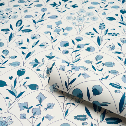 Blue botanical pattern with leaves and small flowers in circular motifs on white background; wallpaper or fabric.