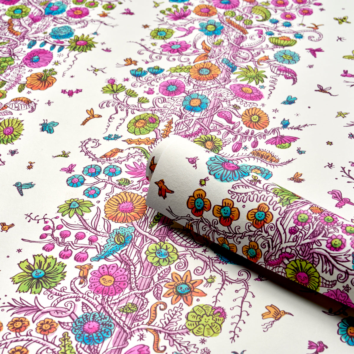 White paper with a vibrant whimsical botanical print of pink, purple, blue and orange flowers and vines; rolled corner.