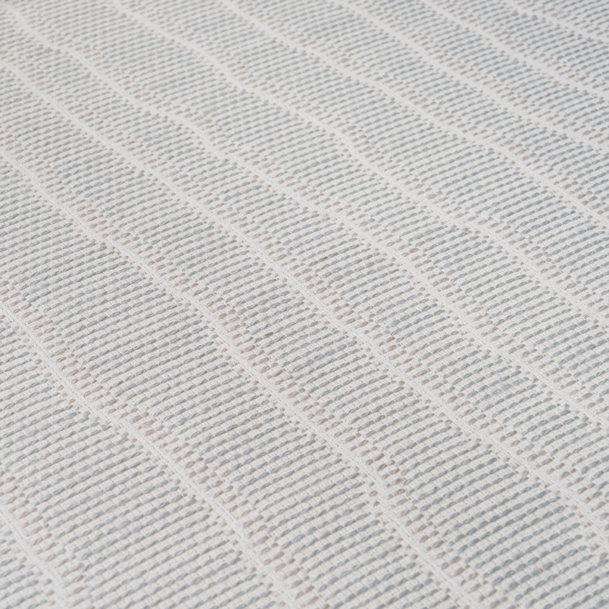 Close-up of a Whisper Blue wallcovering with a textured, raised wavy rib pattern.