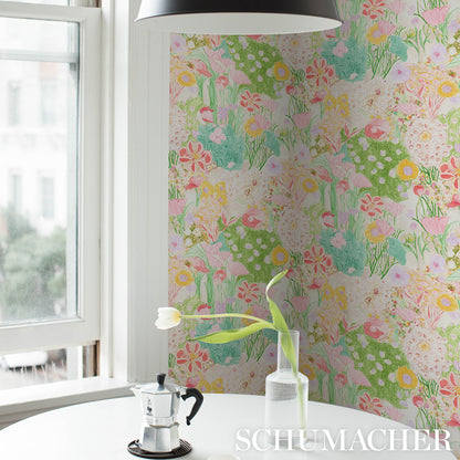 Bright kitchen nook with pastel floral wallpaper, glass vase tulip, stovetop espresso maker, white table, black pendant lamp.