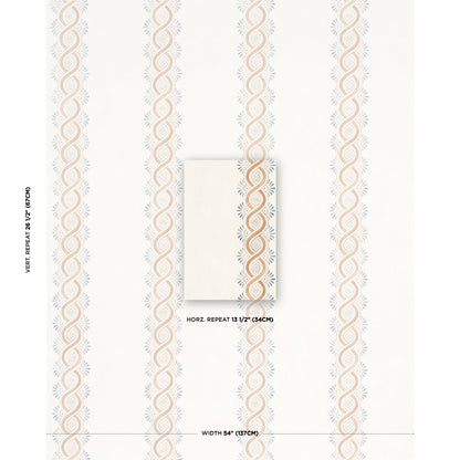 Beige wallpaper with peach interlocking loops and pale blue sunbursts; center white swatch; 54 inch width, 13.5 inch repeat.