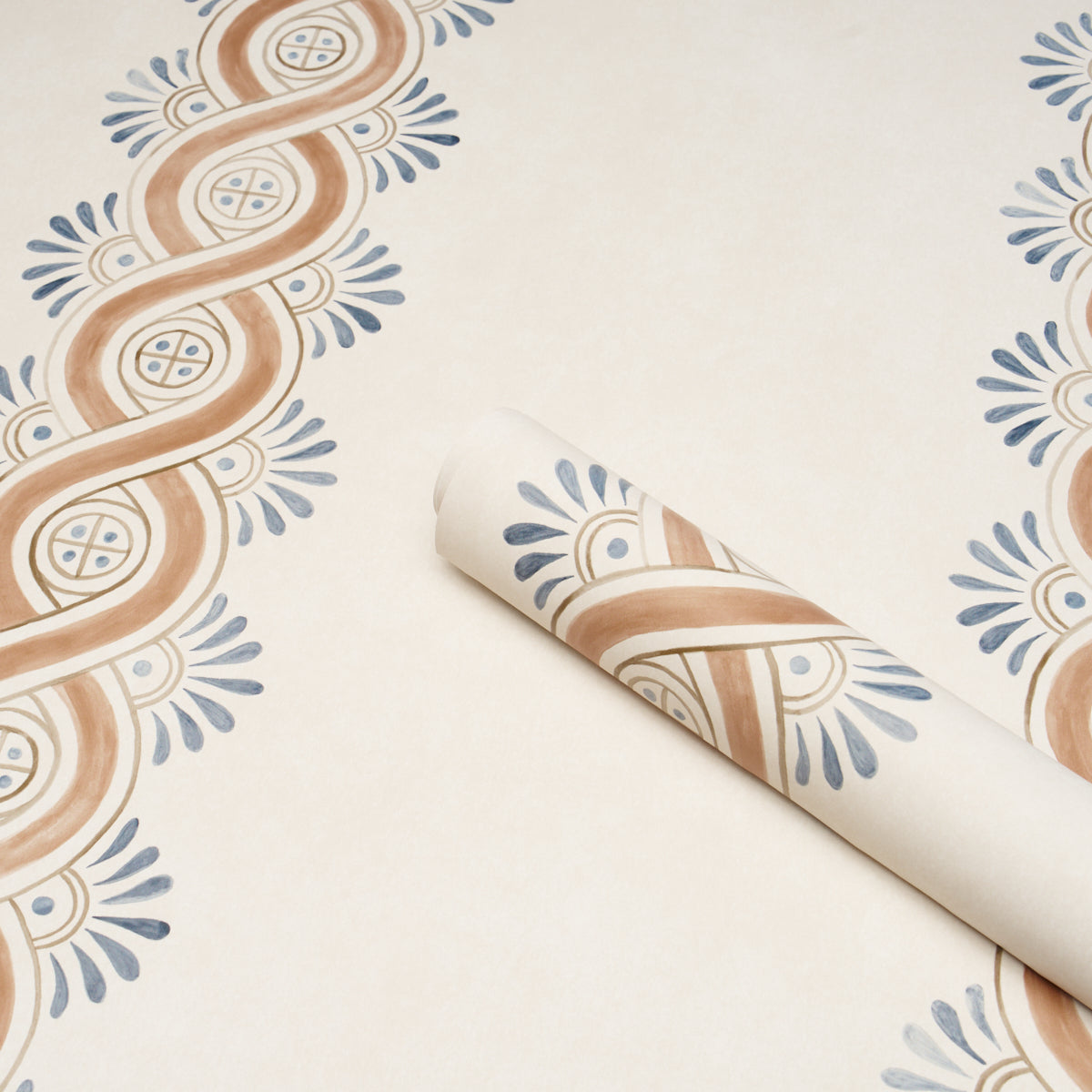 Rolled beige wallpaper sample with brown looping stripes and blue floral accents for vintage decor.