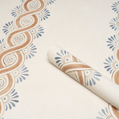 Rolled beige wallpaper sample with brown looping stripes and blue floral accents for vintage decor.