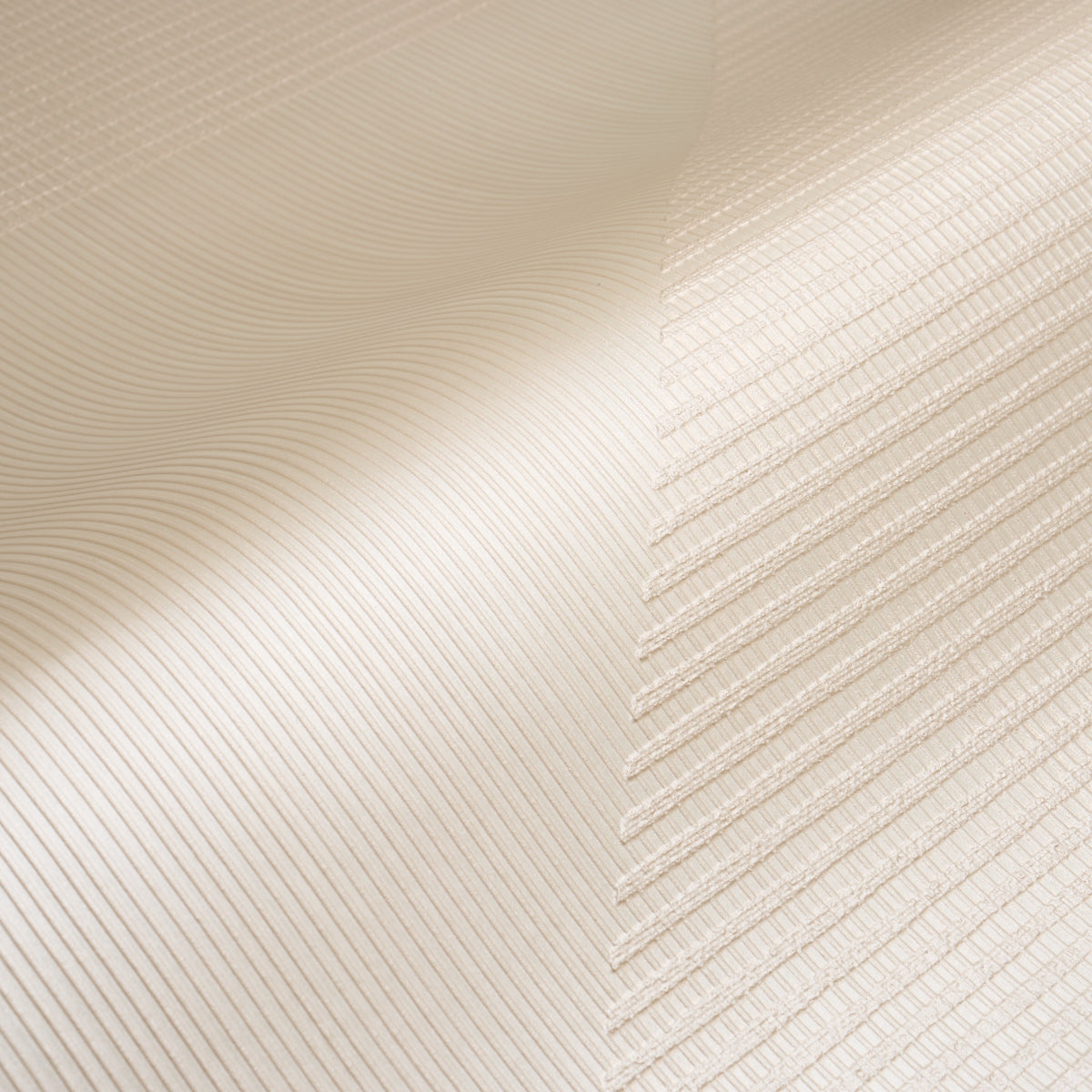 Cream-beige wallcovering with a pearlescent, textured woven finish and a hand-combed triangular pattern.