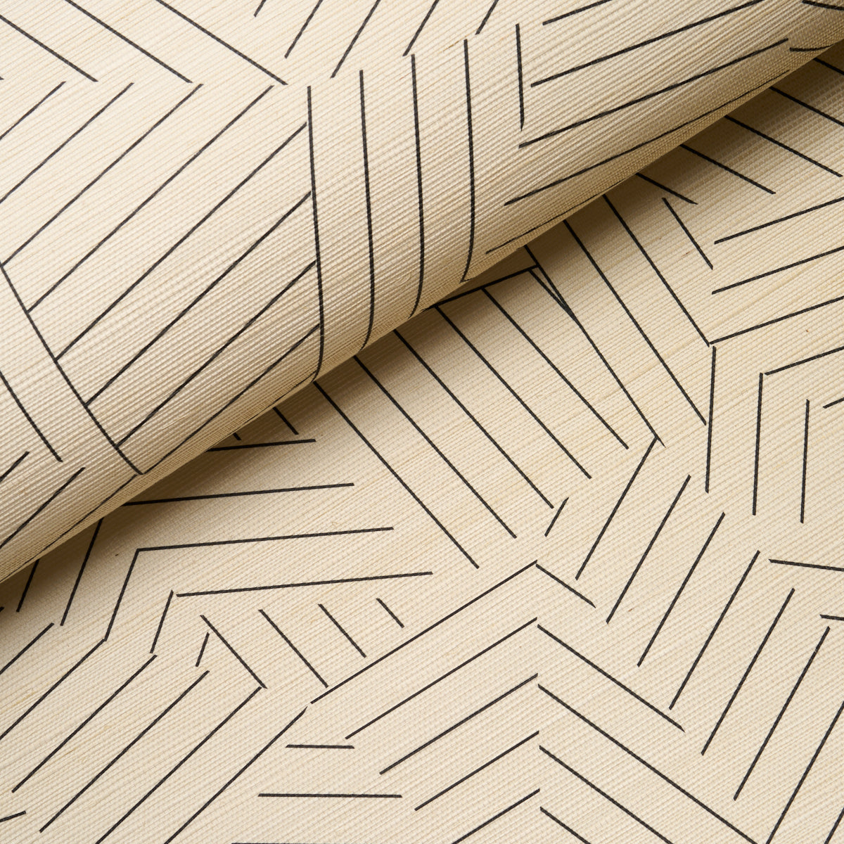 Beige wallcovering with a black deconstructed stripe sisal pattern, folded at the top corner.