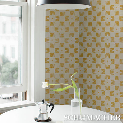 Bright kitchen nook: white round table with moka pot, tulip in a glass vase, sisal maize wallpaper, black pendant lamp.