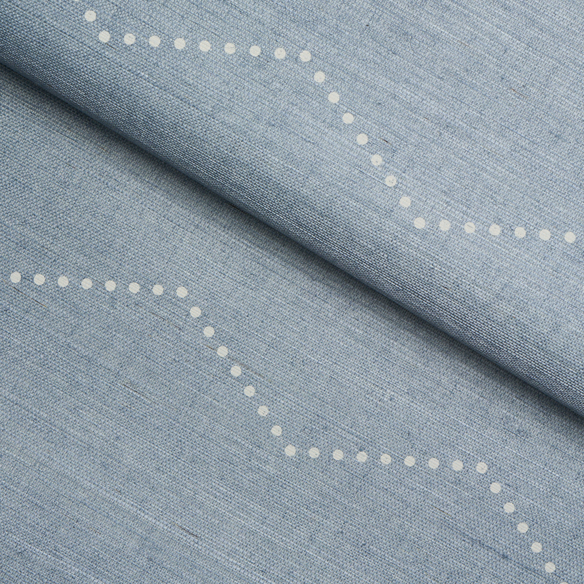 Light blue chambray fabric with white dotted curved lines.