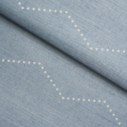 Light blue chambray fabric with white dotted curved lines.