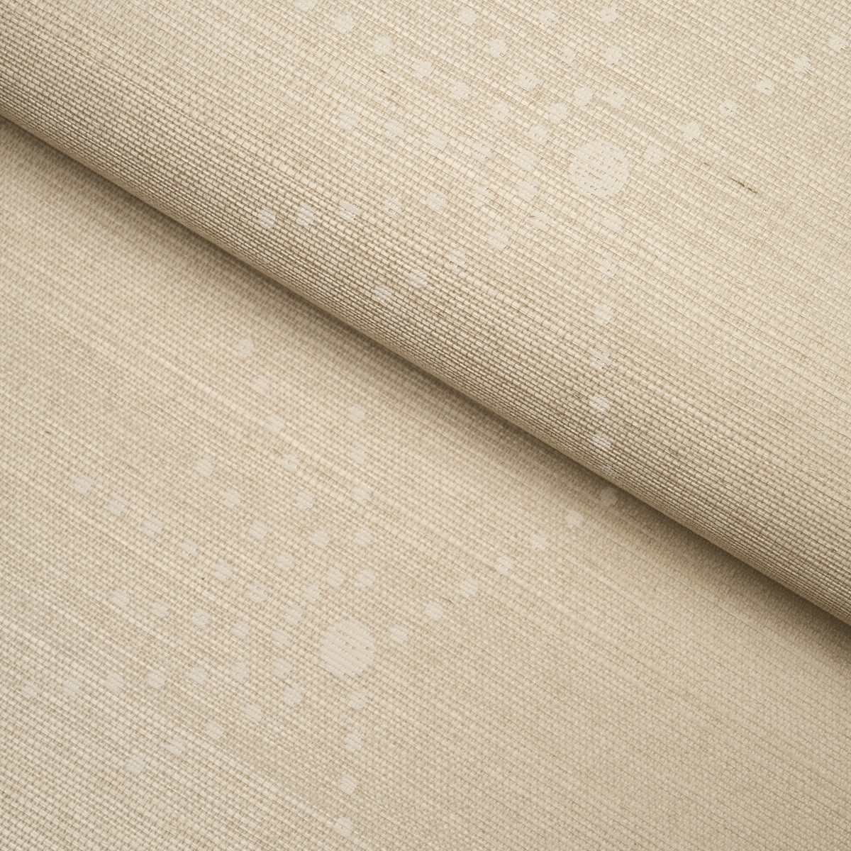 Beige speckled linen fabric folded; soft woven texture with white dot speckles, suitable for upholstery or drapery.