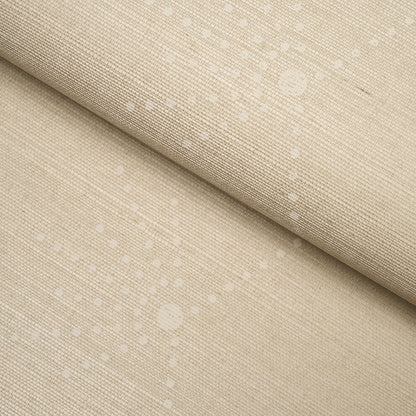 Beige speckled linen fabric folded; soft woven texture with white dot speckles, suitable for upholstery or drapery.