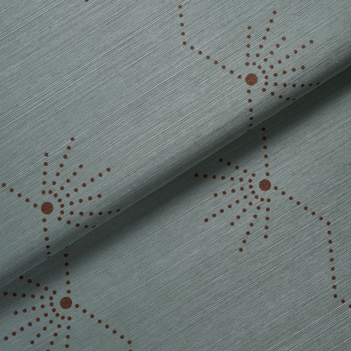 Teal fabric with brown dotted starburst motifs & a fine diagonal weave texture; decorative upholstery material.