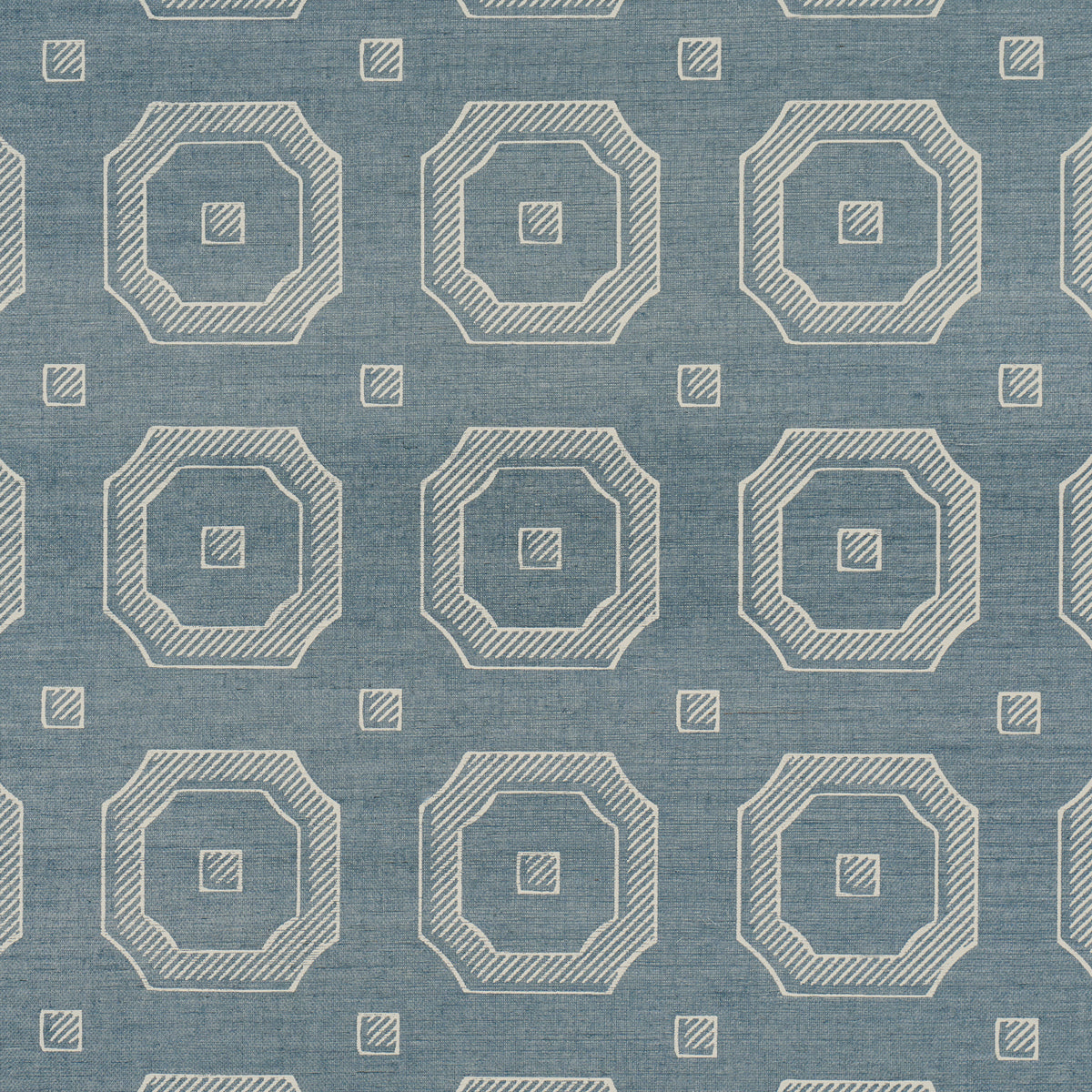 Blue denim-like textured wallcovering with beige striped nested octagons and small squares in a repeating geometric pattern.