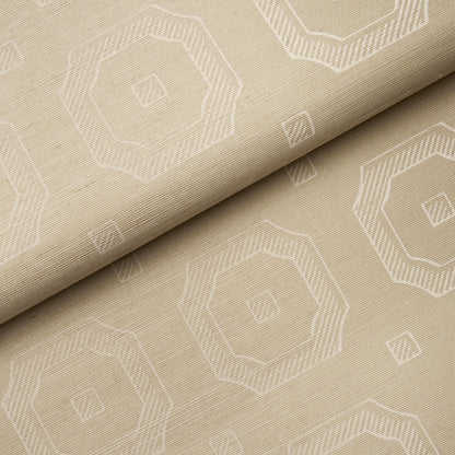 Beige fabric with white geometric octagon pattern; folded, woven texture for upholstery or drapes.