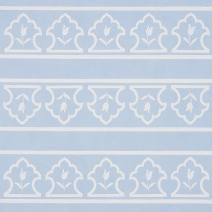 Light blue wallpaper with white arched damask motifs and leaf scrolls in horizontal bands.
